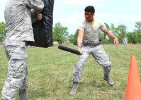 Airman 1st Class Alex Livingston, 319th Security Forces Squadron installation entry controller, practices blows with a baton as he endures the effects of oleoresin capsicum spray in his eyes, nose and mouth during training May 29, 2018, on Grand Forks Air Force Base, North Dakota. Defenders with the 319 SFS must pass this training as a requirement for their career field and in order to carry OC spray on duty. (U.S. Air Force photo by Airman 1st Class Elora J. Martinez)