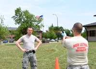 Staff Sgt. Zachary Conn, military working dog handler with the 319th Security Forces Squadron, left, braces himself as Tech. Sgt. Paul Melicia, 319 SFS noncommissioned officer in charge of training, sprays oleoresin capsicum in Conn’s face during training May 29, 2018, on Grand Forks Air Force Base, North Dakota. After being sprayed, training participants completed a course that tested their ability to maintain composure while under duress. (U.S. Air Force photo by Airman 1st Class Elora J. Martinez)