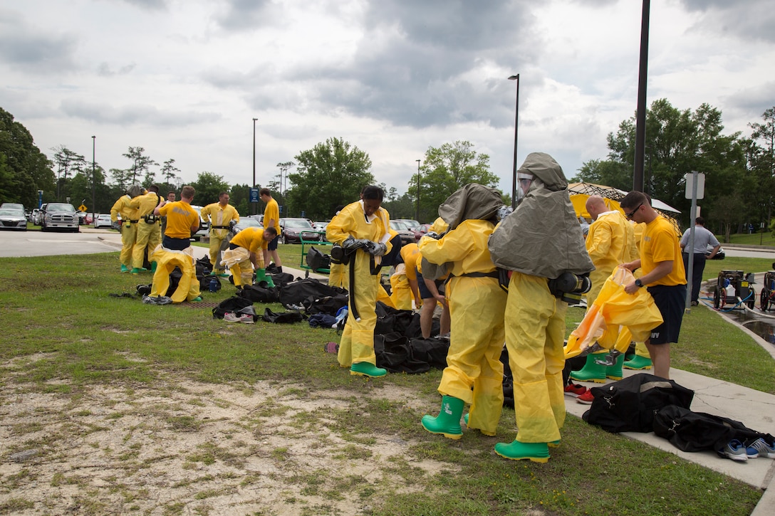 Naval personnel put on protective gear to conduct a decontamination drill at the Naval Medical Center Camp Lejeune, Marine Corps Base Camp Lejeune, May 24, 2018.