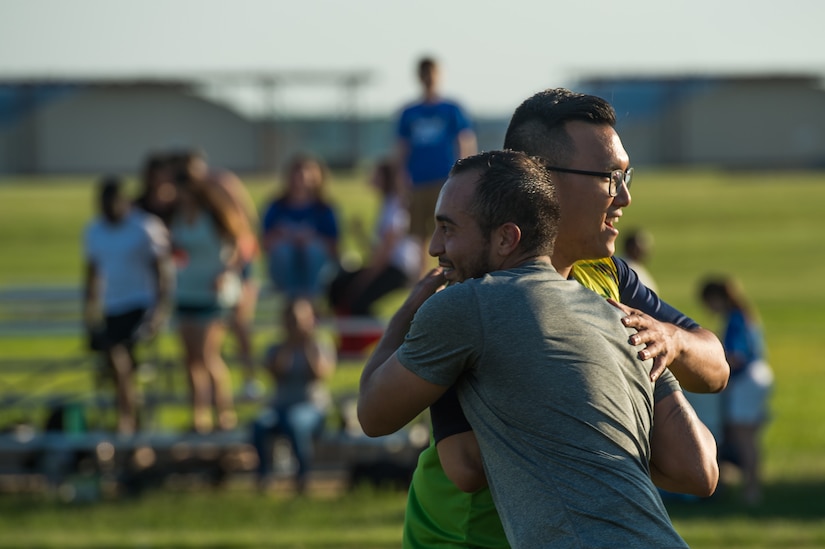 (Front) Juan Oreallan 633rd Medical Group team forward, and (back) U.S. Air Force Airman 1st Class Jae Park, 735th Supply Chain Operations Group team defender, congratulate each other after the Intramural Soccer Championship at Joint Base Langley-Eustis, Virginia, June 4, 2018.