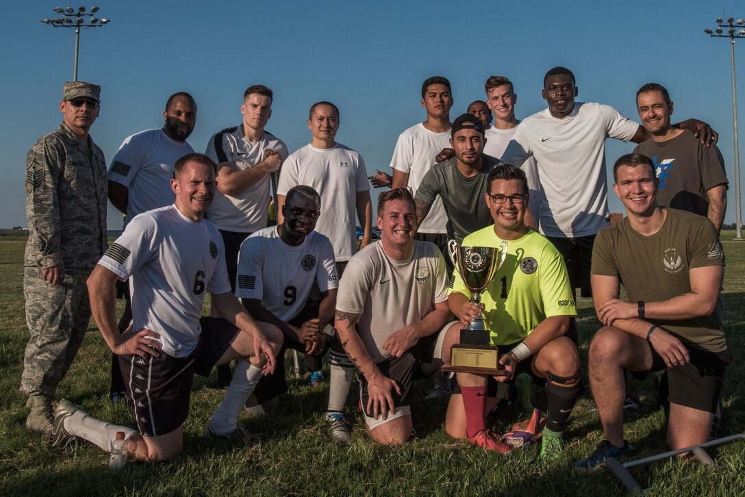 The 633rd Medical Group soccer team poses for a photo with the trophy after winning the Intramural Soccer Championship at Joint Base Langley-Eustis, Virginia, June 4, 2018.