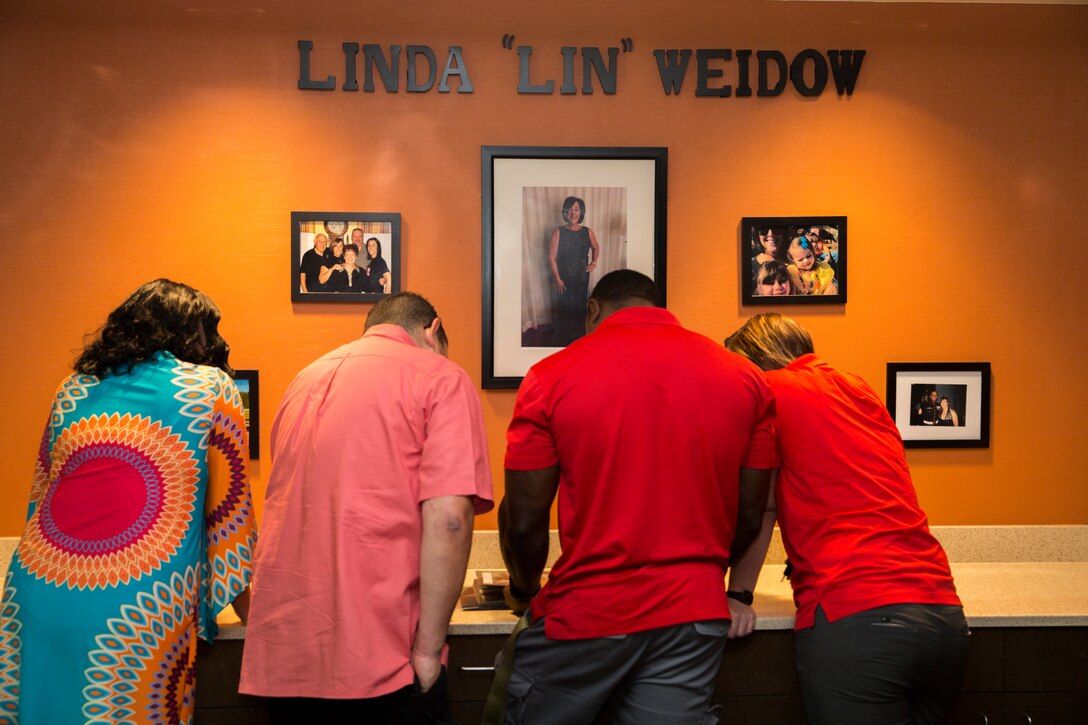 Friends and colleagues of Linda “Lin” Weidow, a former medical advisor at Wounded Warrior Battalion – East, who died Dec. 18, 2017, review photos of her during a room dedication ceremony on Marine Corps Base Camp Lejeune, May 24.