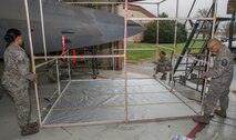 U.S. Air Force Airmen assigned to the 1st Maintenance Squadron Low Observable Flight construct the skeletal structure of a portable paint booth at Joint Base Langley-Eustis, Virginia, March 1, 2018.