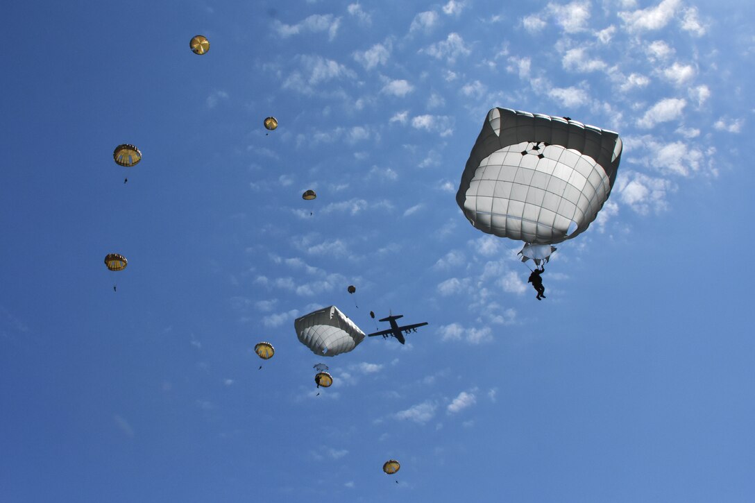 Various paratroopers jumped into the Iron Mike Drop Zone in Sainte Mere Eglise, France