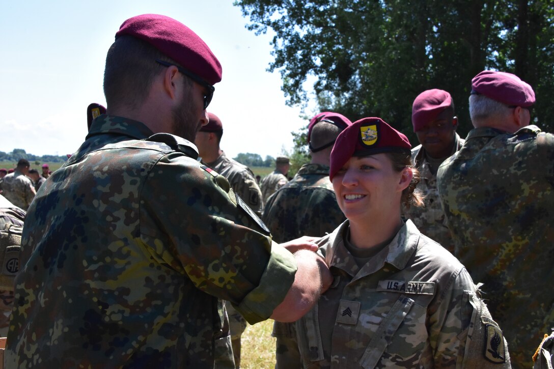 Sgt. Clymer gets pinned with German Jump wings after she jumped from a German aircraft.