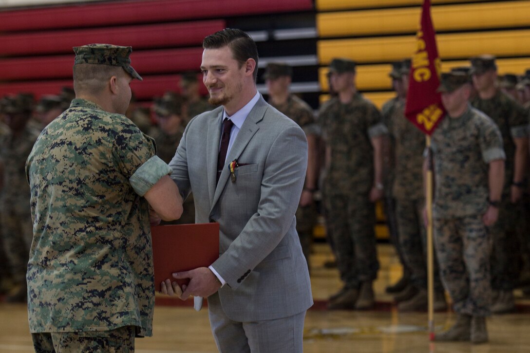 Sean-Paul Donovan, a former sergeant with 2nd Radio Battalion, II Marine Expeditionary Force Information Group is awarded the Navy and Marine Corps Medal at Camp Lejeune, N.C., May 17, 2018. The Navy and Marine Corps Medal is the highest non-combatant decoration awarded. Donovan received this award for saving the life of one of his fellow Marines. (U.S. Marine Corps photo by Lance Cpl. Tiana Boyd)