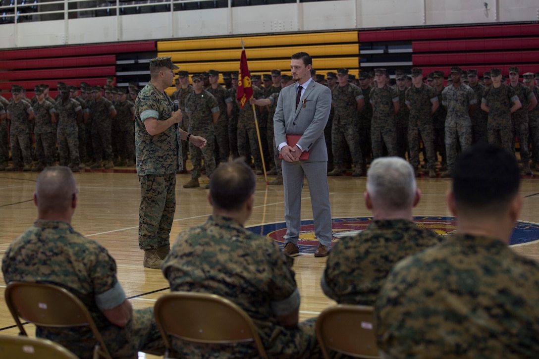U.S. Marine Lt. Col. Bradley Bean, commanding officer of 2nd Radio Battalion, II Marine Expeditionary Force Information Group, gives his remarks about Sean-Paul Donovan, a former sergeant with 2nd Radio Battalion, II Marine Expeditionary Force Information Group, during an award ceremony at Camp Lejeune, N.C., May 17, 2018. The Navy and Marine Corps Medal is the highest non-combatant decoration awarded. Donovan received this award for saving the life of one of his fellow Marines. (U.S. Marine Corps photo by Lance Cpl. Tiana Boyd)