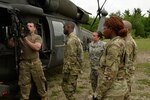 New York Army National Guard Spc. Adam Proctor, assigned to Echo Company, of 3rd Battalion, 142nd Aviation, instructs Soldiers on how to remove empty shells from the brass bag on an M240, on Fort Drum, N.Y., June 2, 2018. Proctor and his company were conducting Aerial Gunnery training to prepare for the National Training Center.