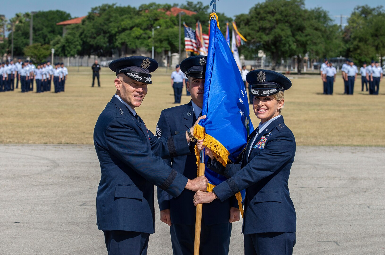 U.S Air Force Lt. Gen. Steve Kwast, commander of Air Education and Training Command, passes the guidon to Brig. Gen. Laura L. Lenderman during the 502nd Air Base Wing and Joint Base San Antonio change of command ceremony at JBSA-Fort Sam Houston’s MacArthur Parade Field June 6, 2018. Members of the 502nd ABW provide installation support to 266 mission partners across 11 JBSA operating locations. Lenderman comes to JBSA from Scott Air Force Base, Illinois, where she was Deputy Director-Military, Strategic Plans, Policy and Logistics, U.S. Transportation Command.