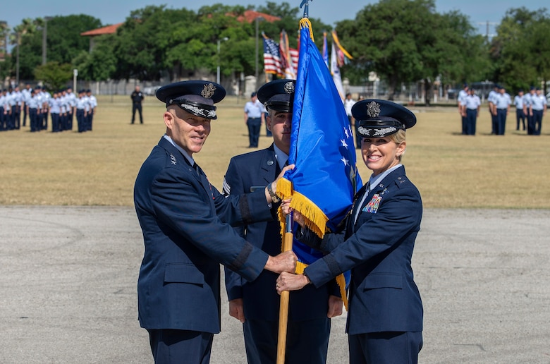 U.S Air Force Lt. Gen. Steve Kwast, commander of Air Education and Training Command, passes the guidon to Brig. Gen. Laura L. Lenderman during the 502nd Air Base Wing and Joint Base San Antonio change of command ceremony at JBSA-Fort Sam Houston’s MacArthur Parade Field June 6, 2018. Members of the 502nd ABW provide installation support to 266 mission partners across 11 JBSA operating locations. Lenderman comes to JBSA from Scott Air Force Base, Illinois, where she was Deputy Director-Military, Strategic Plans, Policy and Logistics, U.S. Transportation Command.