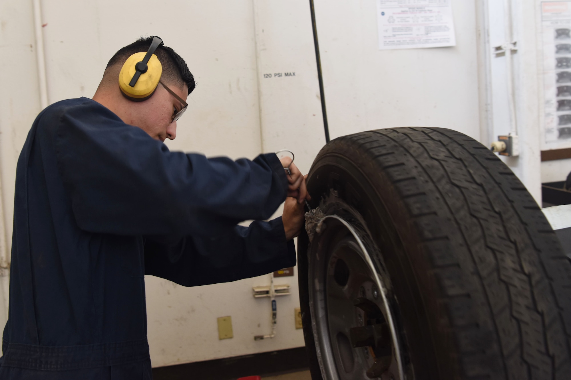 Airman 1st Class Jacobo Abeytia, 30th Logistics Readiness Squadron vehicle maintenance apprentice, loosens the rim from the wheel during a routine tire change, May 29, 2018 at Vandenberg Air Force Base, Calif. Abeytia lubricated the crease of the wheel and the rim to separate and repair the tire. (U.S. Air Force photo by Airman Aubree Milks/Released)