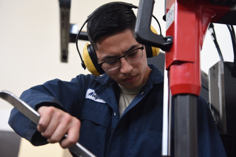 Airman 1st Class Jacobo Abeytia, 30th Logistics Readiness Squadron vehicle maintenance apprentice, changes a wheel during a routine tire change, May 29, 2018 at Vandenberg Air Force Base, Calif. A vehicle maintenance apprentice practices where an automobile is serviced on a regular basis to prevent a major breakdown or the need for major repair. (U.S. Air Force photo by Airman Aubree Milks/Released)