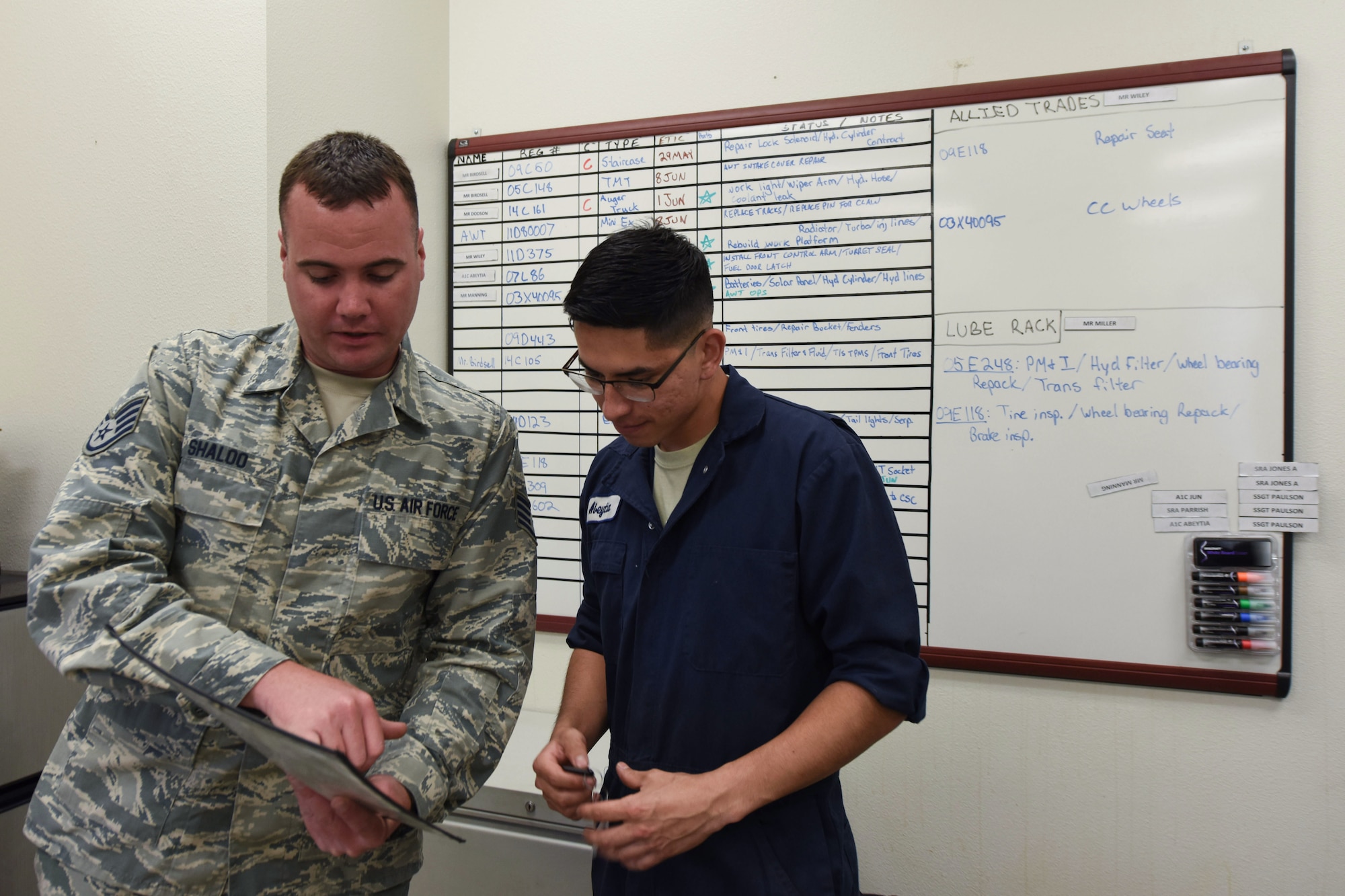 Staff Sgt. Kevin Shaloo, 30th Logistics Readiness Squadron NCO in charge of general purpose, tasks Airman 1st Class Jacobo Abeytia, 30th LRS vehicle maintenance apprentice, May 29, 2018, at Vandenberg Air Force Base, Calif. Shaloo was given a work order informing him of a customer needing a tire change. (U.S. Air Force photo by Airman Aubree Milks/Released)