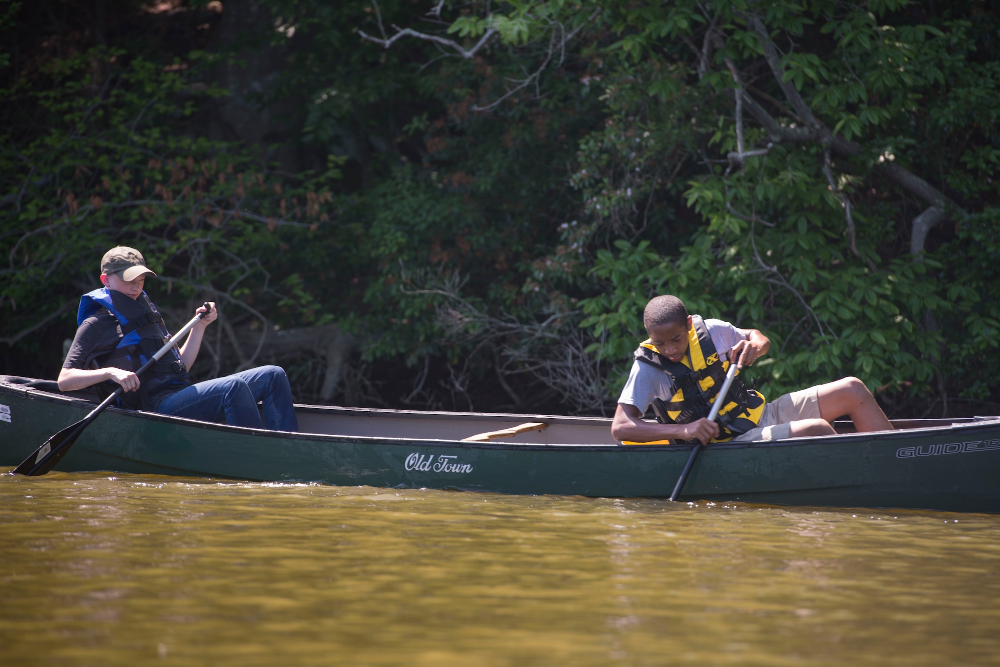 From left, Nicholas Burney, 14, and Cortavious Jones, 13, Fort Eustis Boy Scouts Troop 45 members, pick trash out of Eustis Lake during Clean the Bay Day at Joint Base Langley-Eustis, Virginia, June 2, 2018. Troop 45 members worked to clear the lake of trash, and are thinking of new ways to help clean up Fort Eustis. (U.S. Air Force photo by Airman 1st Class Monica Roybal)