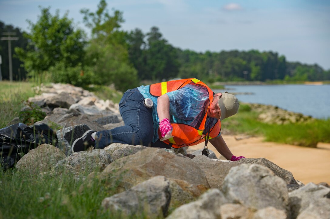 Susan Franks, Joint Task Force Civil Support watch officer, picks up trash during Clean the Bay Day at Joint Base Langley-Eustis, Virginia, June 2, 2018. Litter and debris are some of the largest threats to the marine environment, yielding an extensive impact on species that depend on healthy water to thrive. (U.S. Air Force photo by Airman 1st Class Monica Roybal)
