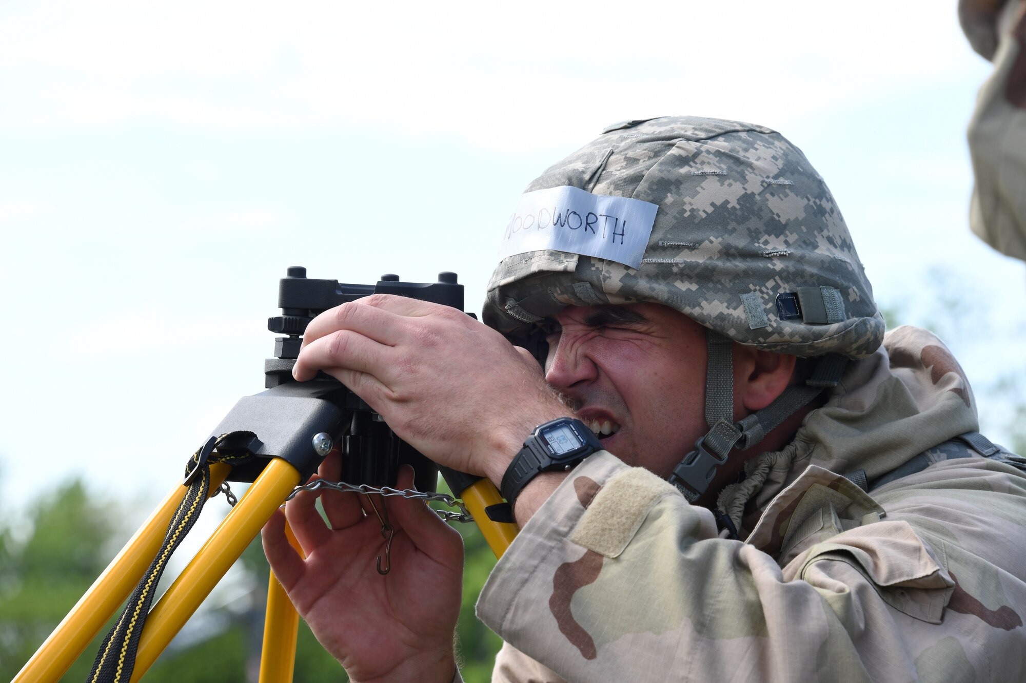 Airman 1st Class Robert Woodworth, engineer apprentice with the 319th Civil Engineer Squadron, uses optical survey equipment to provide accuracy to the pavement and construction Airmen building a berm during a training June 1, 2018, on Fargo Air National Guard Base, North Dakota. Engineer apprentices are essential during war-time missions, to efficiently organize structures when building a new base. (U.S. Air Force photo by Airman 1st Class Elora J. Martinez)