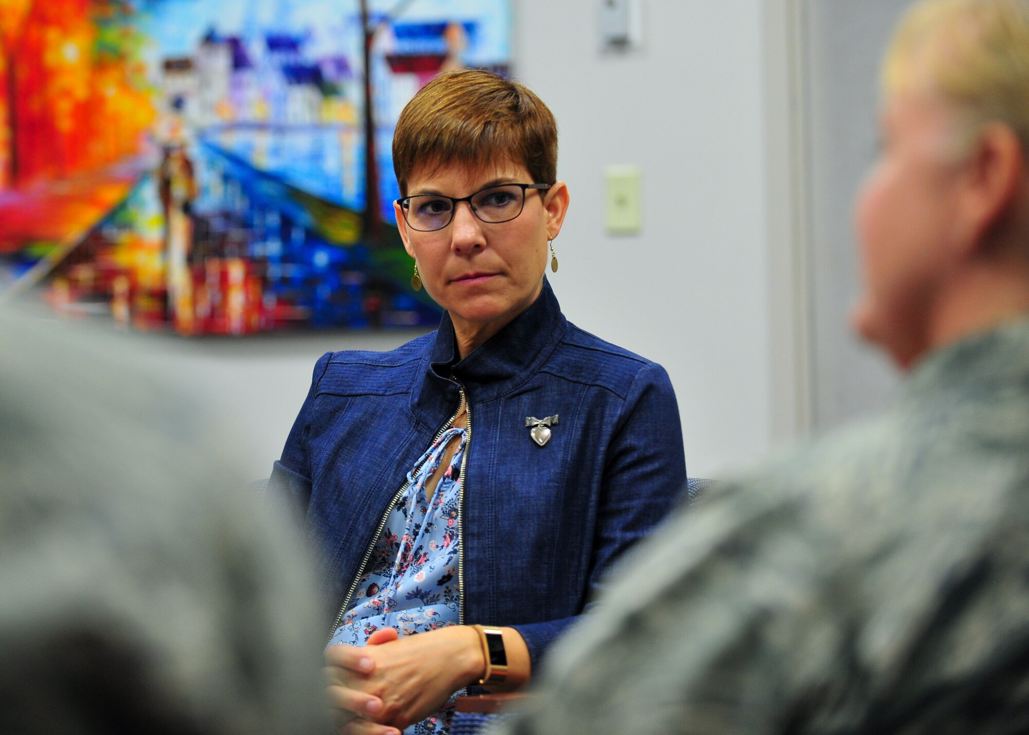 Jill La Fave, a 22nd Air Force Key Spouse and wife of 22nd Air Force Commander Maj. Gen. Craig La Fave, listens as Maj. Nadine Thomas, a 910th Airlift Wing Sexual Assault Prevention and Response advocate, explains prevention efforts and reporting procedures, June 2, here.