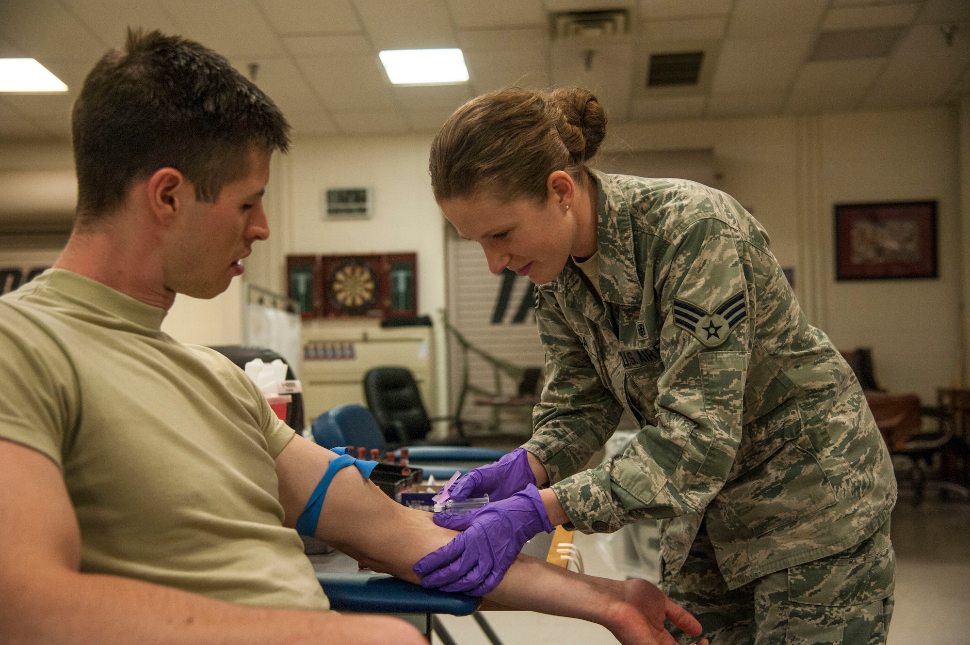 Senior Airman Rocquisha Locke inoculates Airman 1st Class Kadienne Simons during an Individual Medical Readiness activity May 24