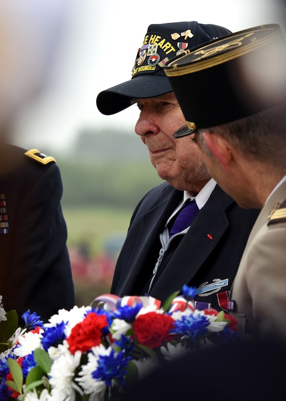 D-Day veteran John Roman prepares to lay a wreath of remembrance during the Utah Beach Federal Monument Ceremony in Sainte-Marie-Du-Mont, France.