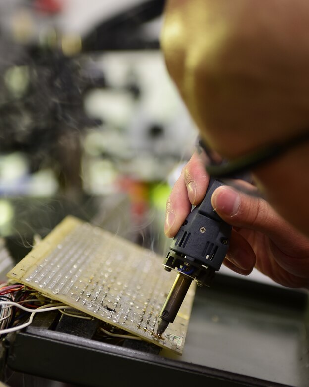 U.S. Air Force Tech. Sgt. Benjamin Sherrill, an Air Force Repair Enhancement Program technician assigned to the 509th Maintenance Group, repairs a burnt power control unit at Whiteman Air Force Base, Missouri, on May 29, 2018. This power control unit is the last available spare in the Air Force, and without repair, some unit could suffer time delays. (U.S. Air Force photo by Staff Sgt. Danielle Quilla)