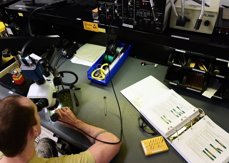 U.S. Air Force Staff Sgt. Christopher Lear, an Air Force Repair Enhancement Program technician assigned to the 509th Maintenance Group, removes the damaged layers from a circuit board at Whiteman Air Force Base, Missouri, on May 29, 2018. AFREP technicians attend certification courses at David-Monthan AFB, Arizona, to be qualified to perform electronic repairs. (U.S. Air Force photo by Staff Sgt. Danielle Quilla)