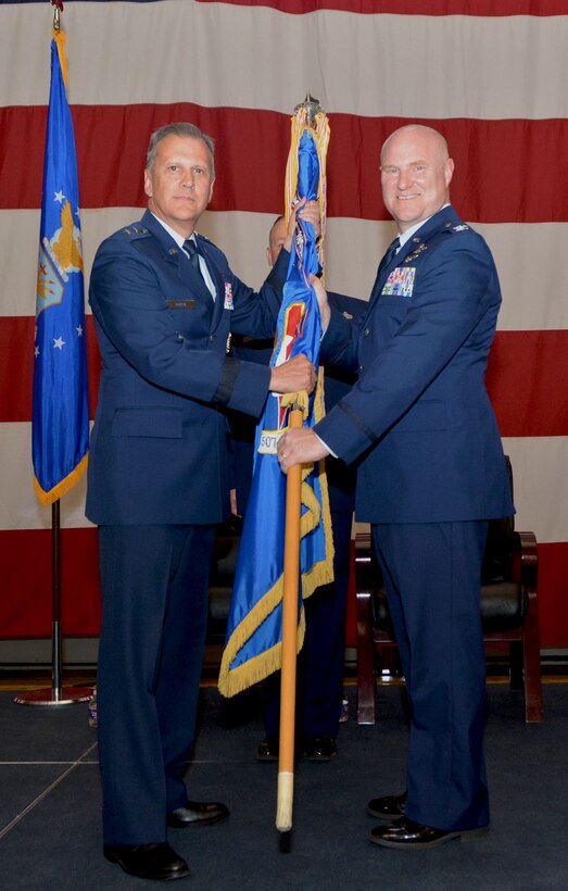 Maj. Gen. Randall Ogden, Fourth Air Force commander, hands the 507th Air Refueling Wing flag to Col. Richard Heaslip, 507th ARW commander, June 3, 2018, at Tinker Air Force Base, Okla. The passing of a flag during a change of command ceremony serves as a visual symbol of command to Airmen within the unit. (U.S. Air Force photo/Tech. Sgt. Samantha Mathison)