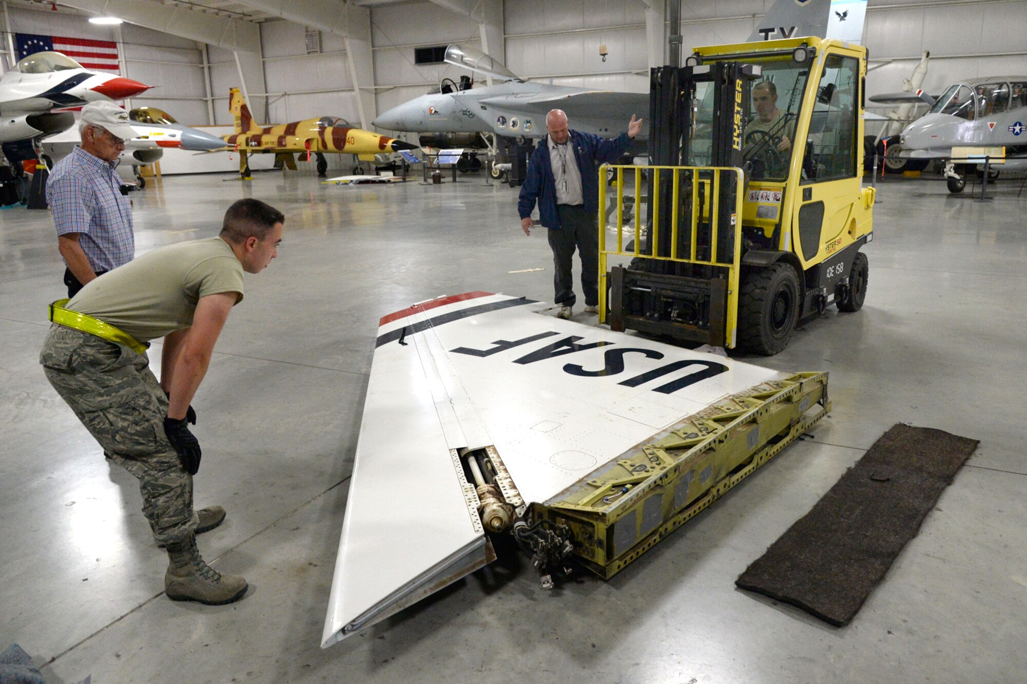 Hill Aerospace Museum staff and volunteers reposition an F-16 wing to be installed on a static display aircraft May 29, 2018, at Hill Air Force Base, Utah. Now located at the east end of the museum’s fighter gallery, the former Thunderbird F-16A aircraft will be on display for visitors. (U.S. Air Force photo by Todd Cromar)