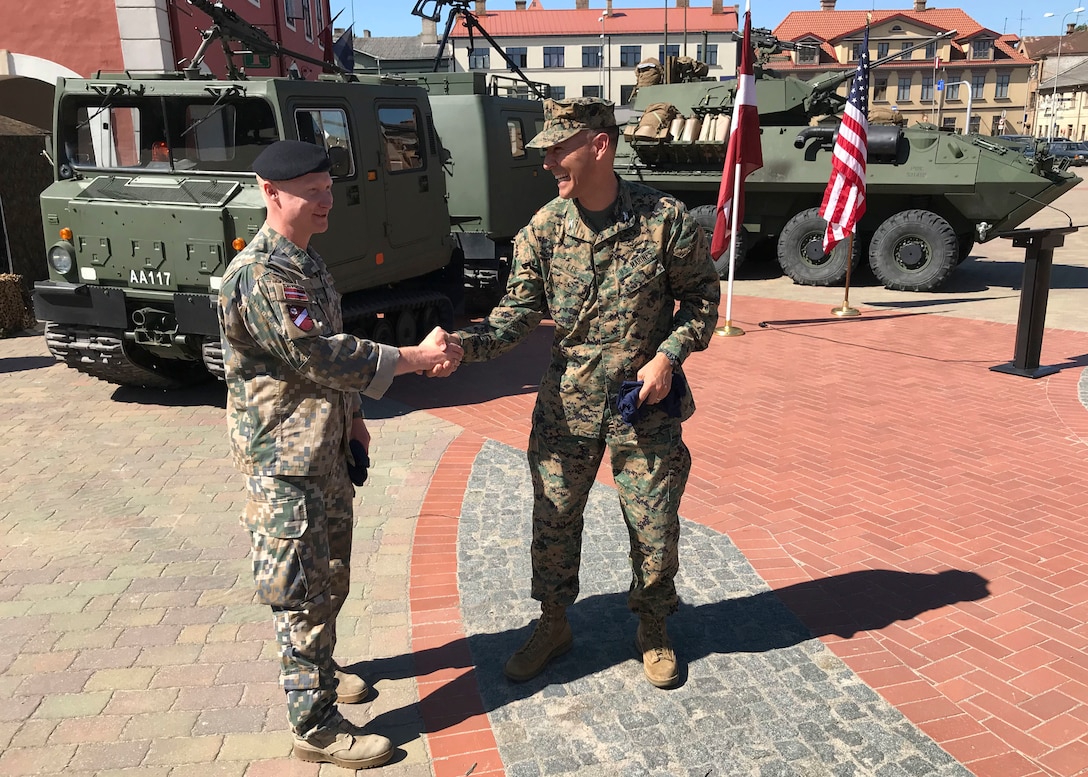 U.S. Marine Corps Col. Peter Lee, head of operations for Marine Forces Europe and Africa thanks Maj. Elmars Popakuls, Commander of Latvian National Guard 53rd Infantry Battalion, during the multinational civil engagement ceremony in Bauska, Latvia June 2, 2018 as part of Exercise Saber Strike 2018. The focus of the ceremony was the integration of multinational forces and the enhancement of the relationships between the U.S. Marines and their Latvian military counterparts. (U.S. Marine Corps Photo by Maj. Greg Wolf/Released)