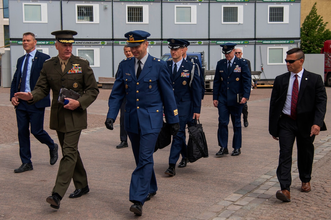 Marine Corps Gen. Joe Dunford, walks with other service members.