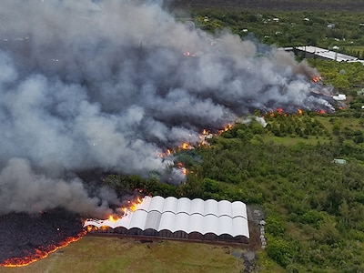 Lava from the Kilauea eruption engulfs a nursery in Kapoho, Hawaii, June 2, 2018. The building was photographed from a UH-60 Black Hawk helicopter during a mission to survey possible landing zones for evacuation of residents in the area.