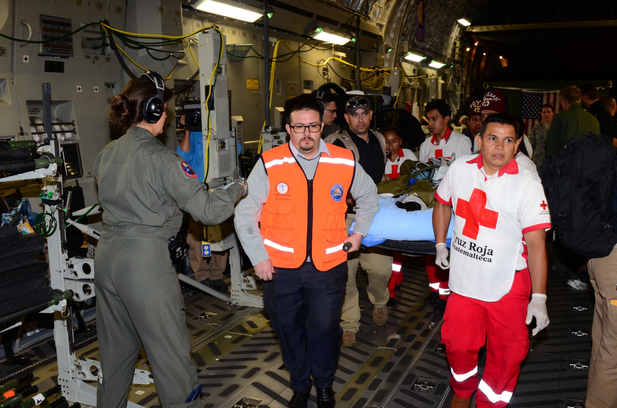 Guatemalan and United States military Fuego relief personnel load critically injured patients onto a 172d Airlift Wing C-17 Globemaster. The humanitarian airlift aeromedical evacuation mission was conducted at the direction of U.S. Southern Command to assist the government of Guatemala following the recent eruption of Fuego Volcano. (U.S. Air Force photo by Tech. Sgt. Edward Staton)