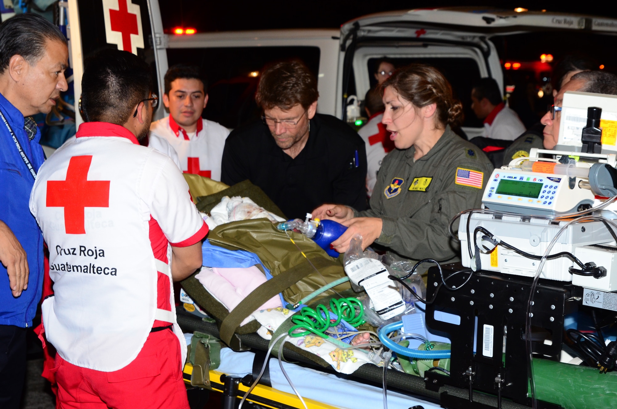 Members of the U.S. Air Force Critical Care Air Transport Team (Pedicatics) assist Guatemalan medical personnel with loading critically injured patients on board a Mississippi Air National Guard C-17 Globemaster III. The aircrew from the 172nd Airlift Wing, transported six children from Guatemala to receive medical treatment in the United States for burns and other injuries sustained during the June 3, 2018 Fuego Volcano eruption. (U.S. Air Force photo by Tech. Sgt. Edward Staton)