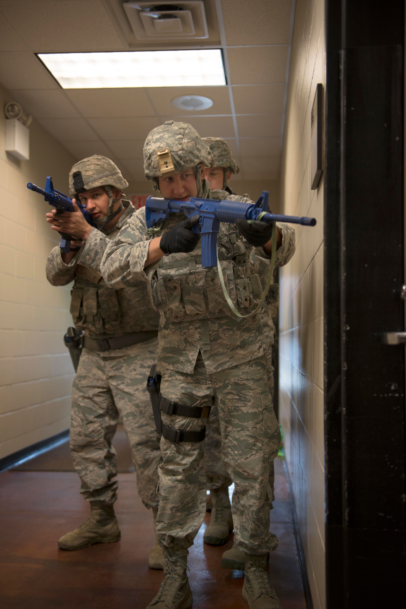 Senior Airman Dolton Hurn, Tech. Sgt. Benjamin Rosengarden and Tech. Sgt. Ryan Ball, 934th Security Forces Squadron fire team members, secure a hallway of the 934th SFS building as part of a room clearing training at Minneapolis Air Reserve Station, Minn., June 3, 2018. Room clearing training helps defenders sharpen skillsets that they could potentially use during a hostile situation. (U.S. Air Force Photo by Tech. Sgt. Amber E. N. Jacobs)