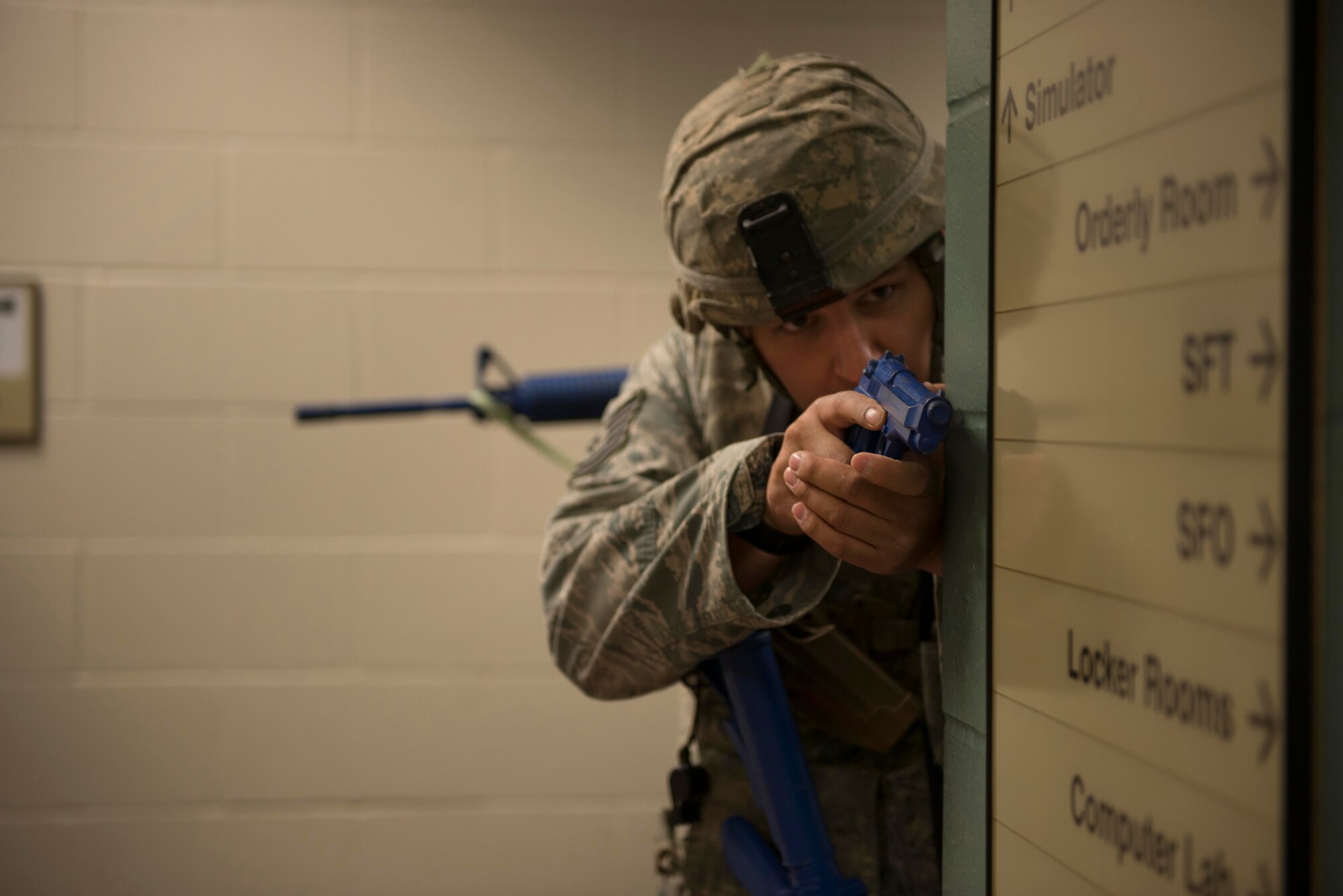 Tech. Sgt. Benjamin Rosengarden, 934th Security Forces Squadron fire team leader, secures a hallway of the 934th SFS building during room clearing training at Minneapolis Air Reserve Station, Minn., June 3, 2018. Security Force members practice job requirements quarterly to maintain their ability to effectively respond to a variety of situations they can encounter while out in the field. (U.S. Air Force Photo by Tech. Sgt. Amber E. N. Jacobs)