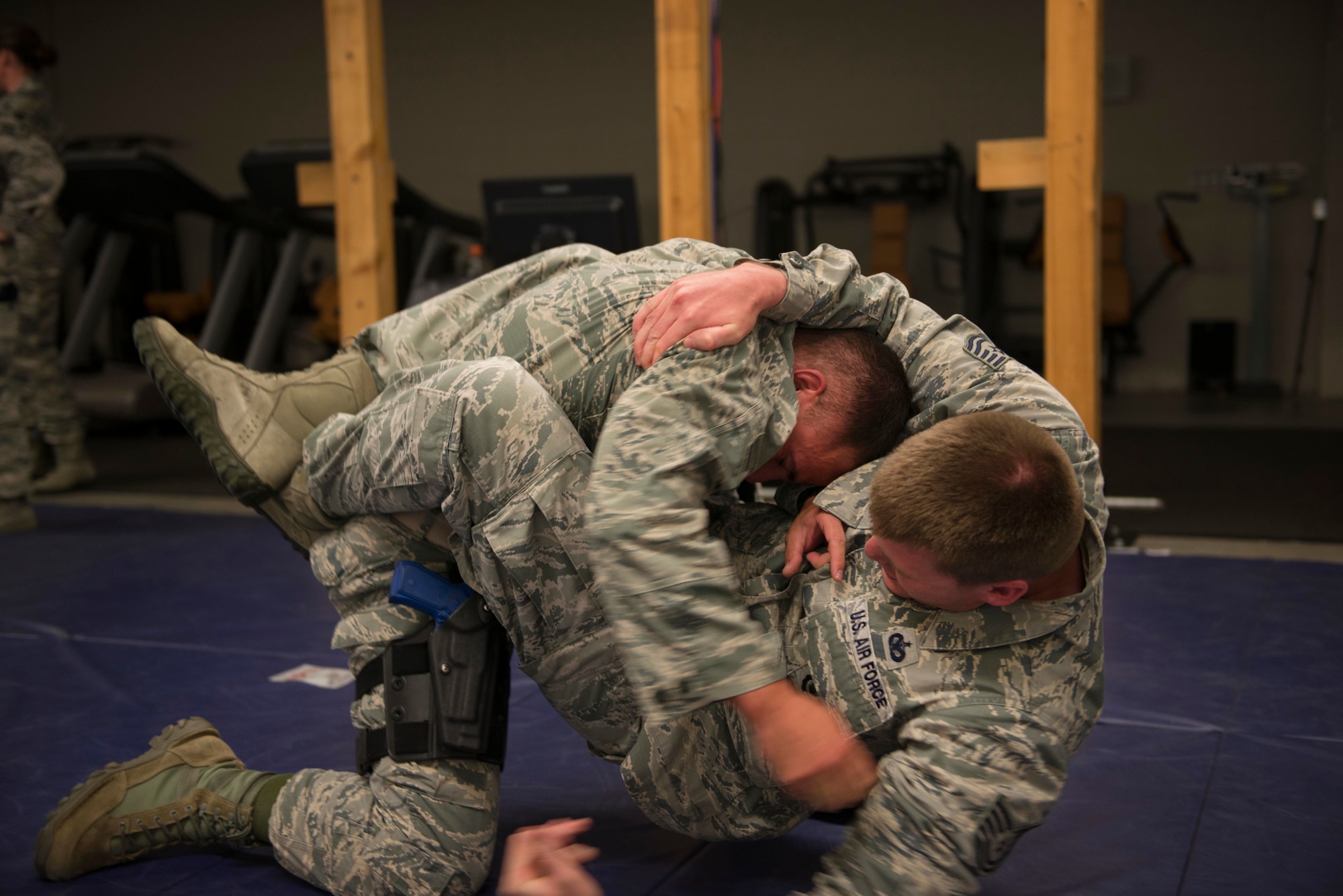 Senior Airman Mitch Koenig wrestles Tech. Sgt. Brandon Klossner, both 934th Security Forces Squadron fire team members, in an attempt to safe guard his weapon from Klossner during a weapon retention training at Minneapolis Air Reserve Station, Minn., June 3, 2018. Airmen from the 934th SFS had to prevent their weapons from being taken by an advisory as part of training scenario. (U.S. Air Force Photo by Tech. Sgt. Amber E. N. Jacobs)