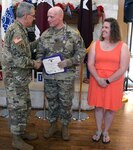 Brooke Army Medical Center Commanding General Brig. Gen. George Appenzeller (left) thanks Purple Heart recipient Sgt. 1st Class James L. Burch (center) for his service during a Purple Heart ceremony at Warrior and Family Support Center June 1 as Burch’s wife, Dixie, looks on.