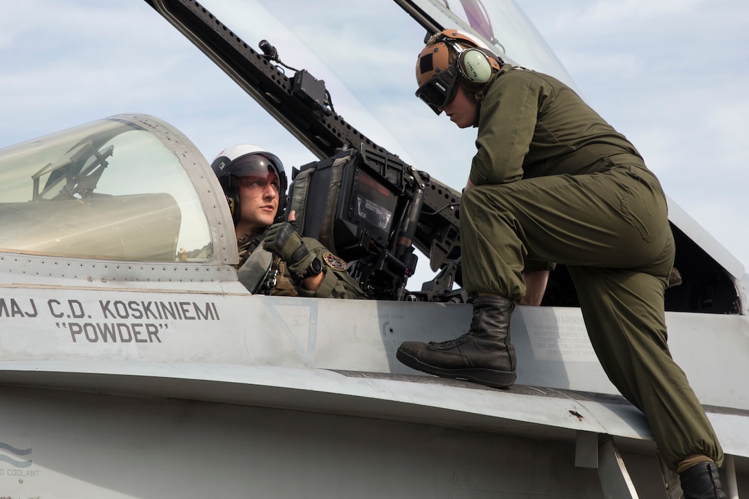 Lance Cpl. Hunter Cathron, right, speaks with Maj. Kevin Bowler prior to take off aboard Marine Corps Air Station Beaufort June 6. Cauthron is the plane captain for this particular aircraft and prior to every flight, he signs off on the inspection, certifying that the pilot is flying an aircraft that is mission ready. At just 23 years old, Cauthron holds the responsibility of ensuring the safety of every Marine on the flight deck before, during and after flight operations and missions. Cauthron is an engine mechanic and plane captain with Marine Fighter Attack Squadron 312.