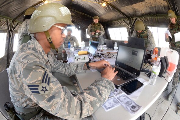 Senior Airman Brandon Peterson, Finance/Contracting Directorate, practices finance work in a “deployed environment” during a field exercise May 3, 2018, at Hill Air Force Base, Utah. (U.S. Air Force photo by Todd Cromar)