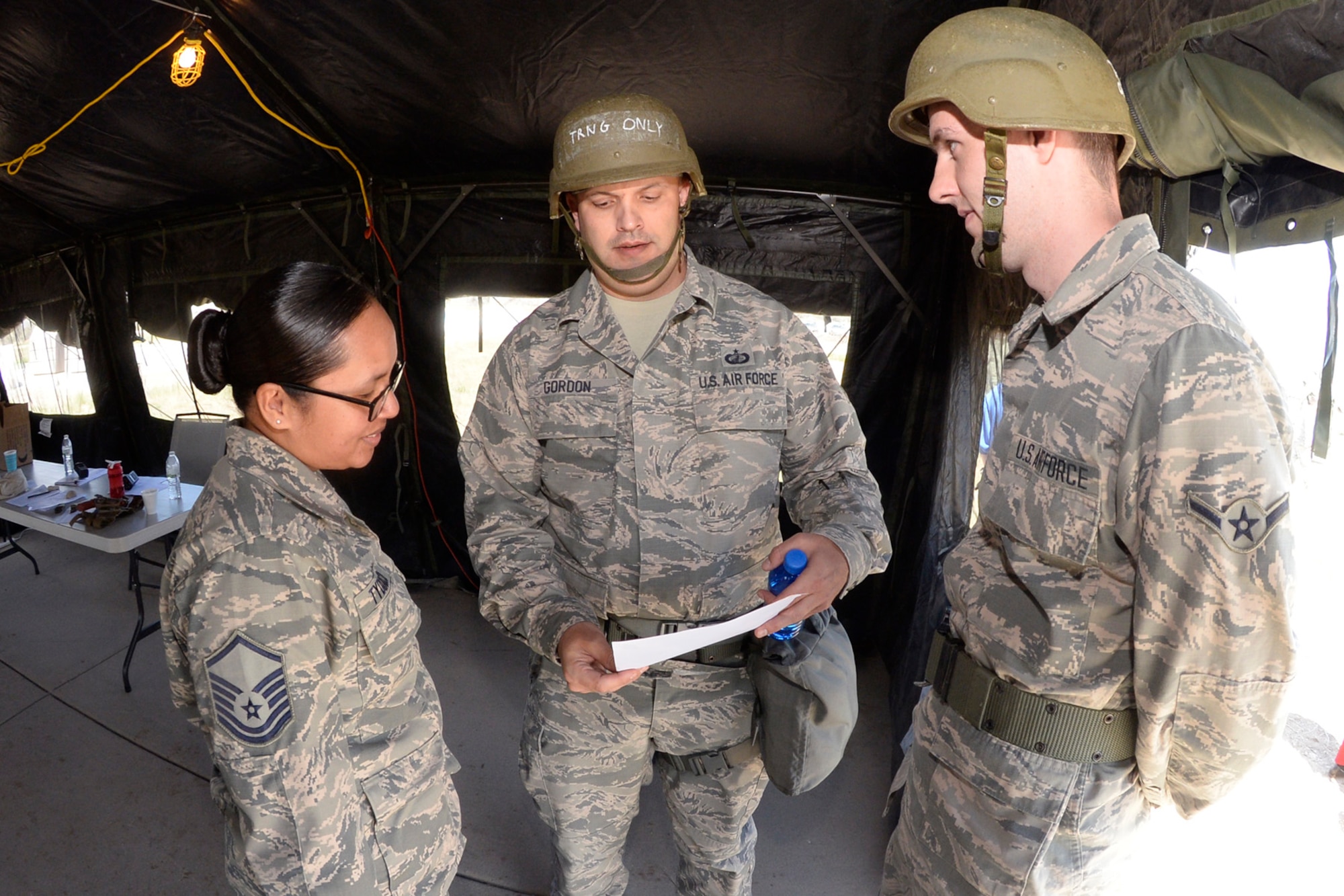 (Left to right) Master Sgt. Darlene Tydingco, Gordon, Contracting Directorate and Airman Andrew Snively, 388th Contracting, practice contracting work in a  “deployed environment” during a field exercise May 3, 2018, at Hill Air Force Base, Utah. (U.S. Air Force photo by Todd Cromar)