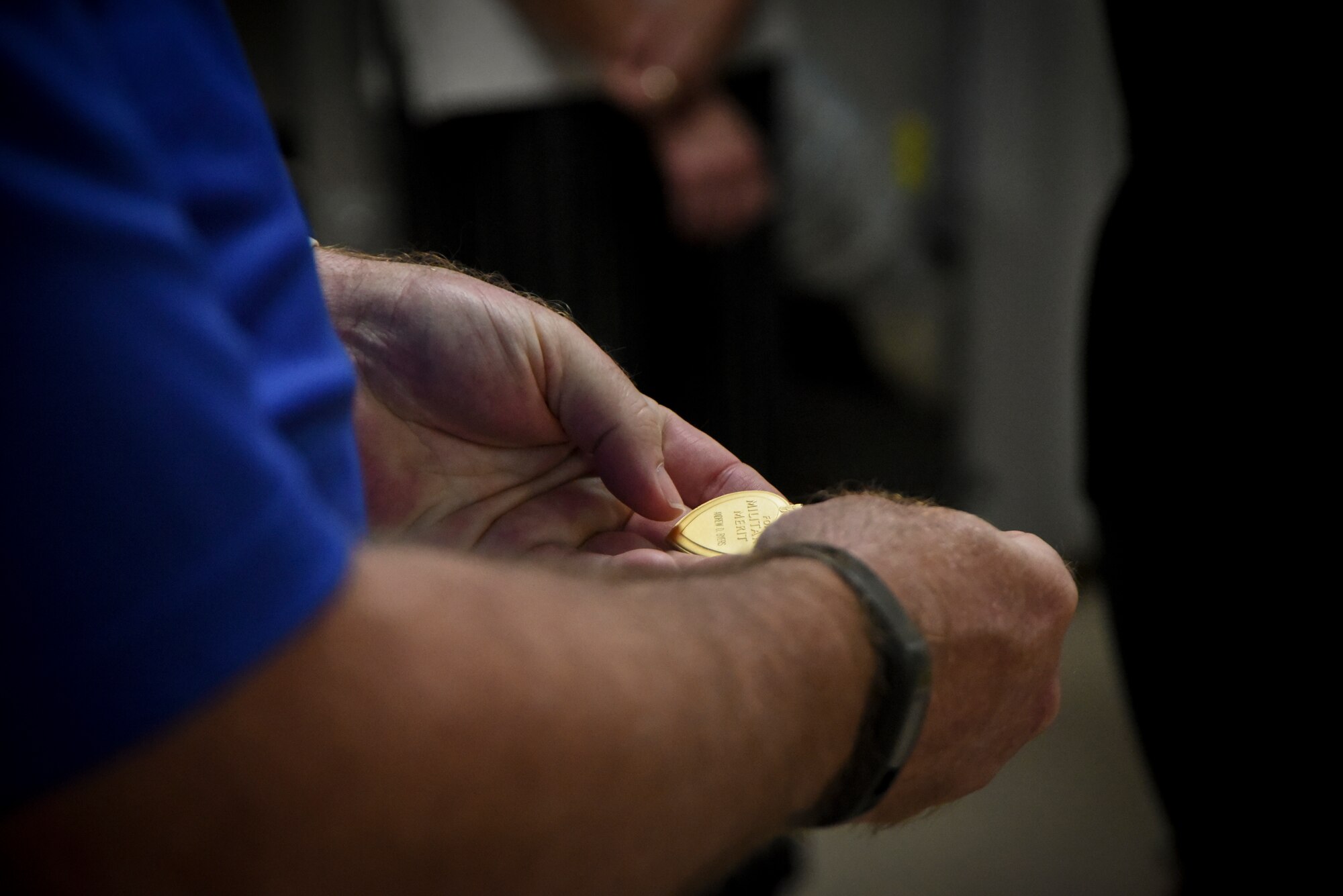 Volunteer holds engraved Purple Heart