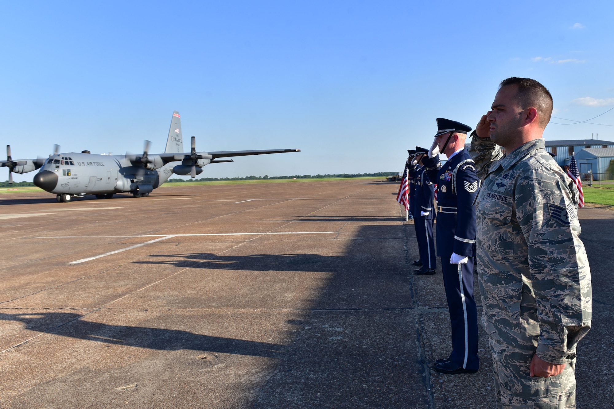 Men salute plane.