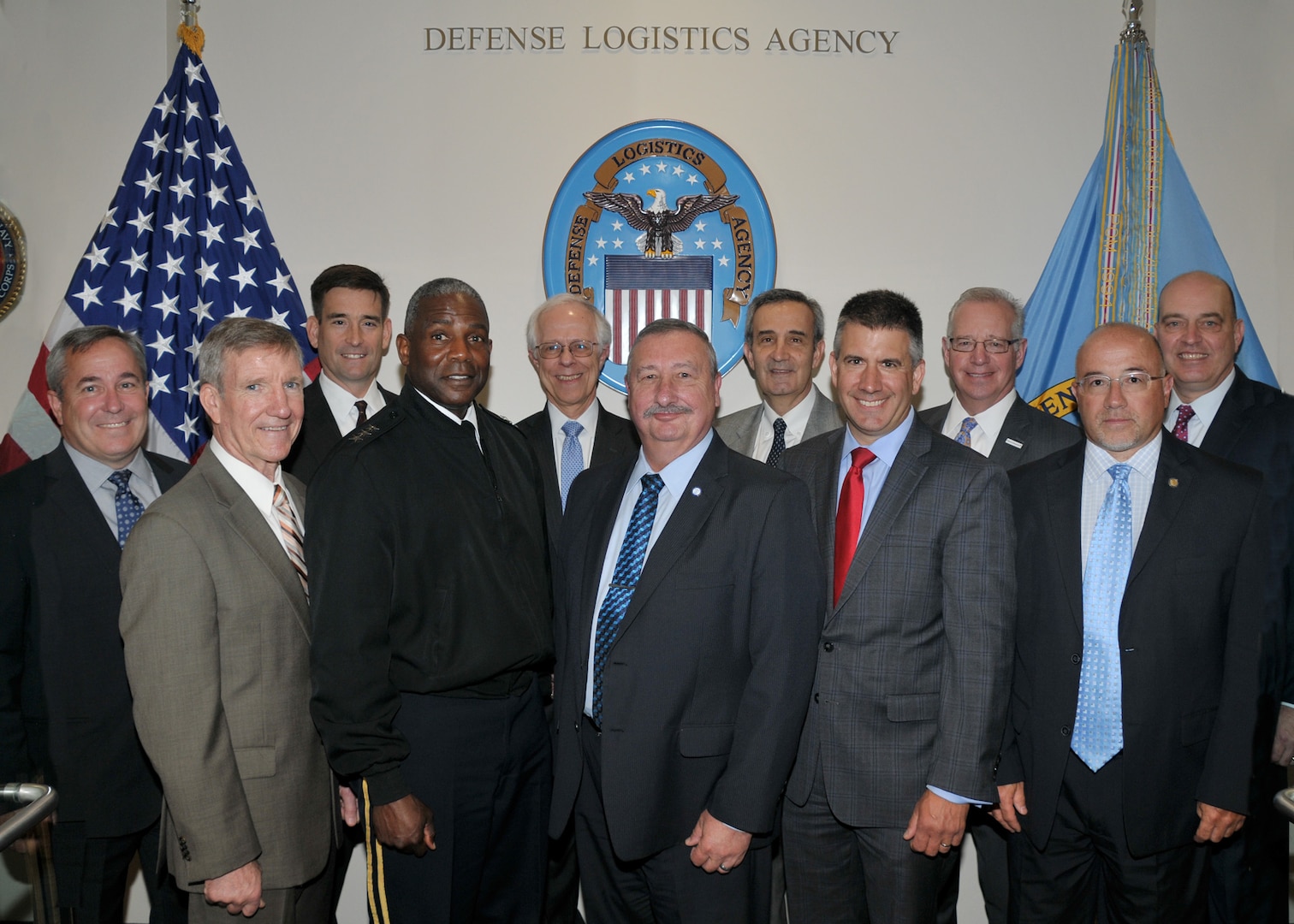 Group of industry leaders and DLA leaders pose before event.