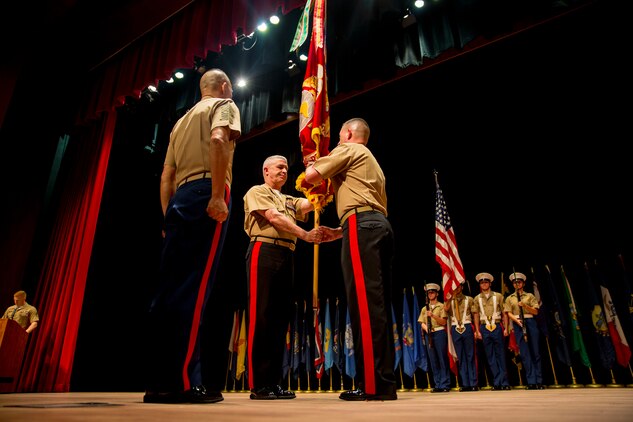 Major General James W. Bierman, Jr. (right), accepts the organizational colors from Maj. Gen. Paul J. Kennedy during the Marine Corps Recruiting Command change of command ceremony at Warner Hall, Marine Corps Base Quantico, Virginia, June 7, 2018.  The ceremony signified the transfer of command from Kennedy to Bierman. (U.S. Marine Corps Photo by Staff Sgt. John A. Martinez Jr.)