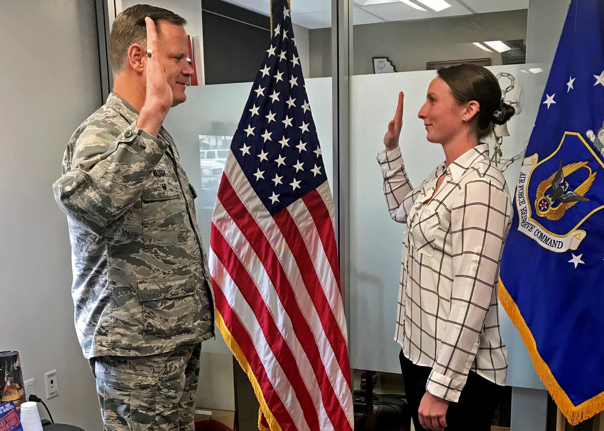 Lt. Col. Joseph Walter, wing process manager for the 442d Fighter Wing, administers the oath of enlistment to soon-to-be 2nd Lt. Margaret “Maggie” Ann Atkins at Whiteman Air Force Base, May 21, 2018.