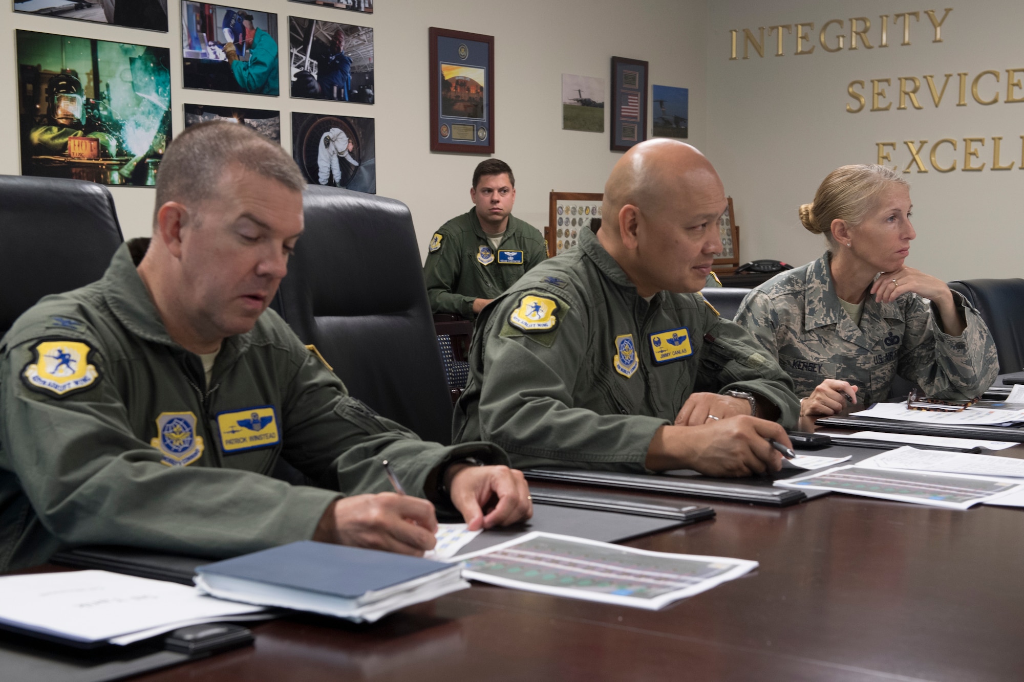 Col. Patrick Winstead, left, 437th Airlift Wing vice commander, and Col. Jimmy Canlas, middle, 437th Airlift Wing commander, and Chief Master Sgt. Jennifer Kersey, right, 437th AW command chief, listen to a pitch during the Squadron Innovation Fund panel meeting June 4, 2018.