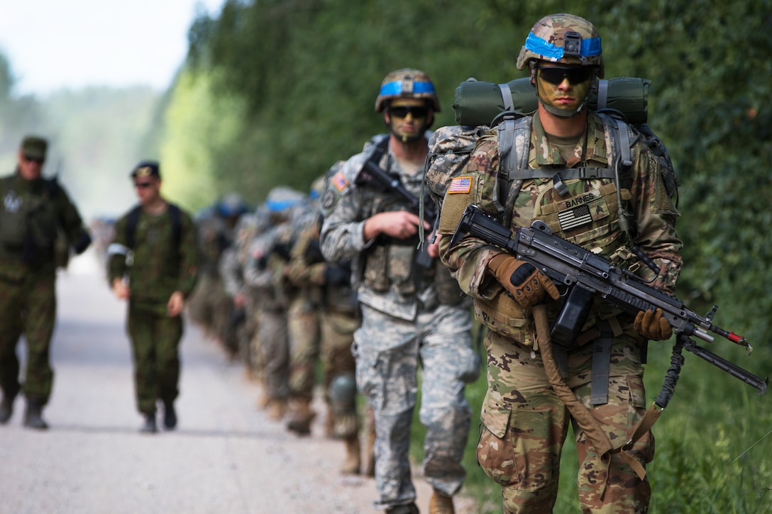 Soldiers march on a road to get into position during the exercise.