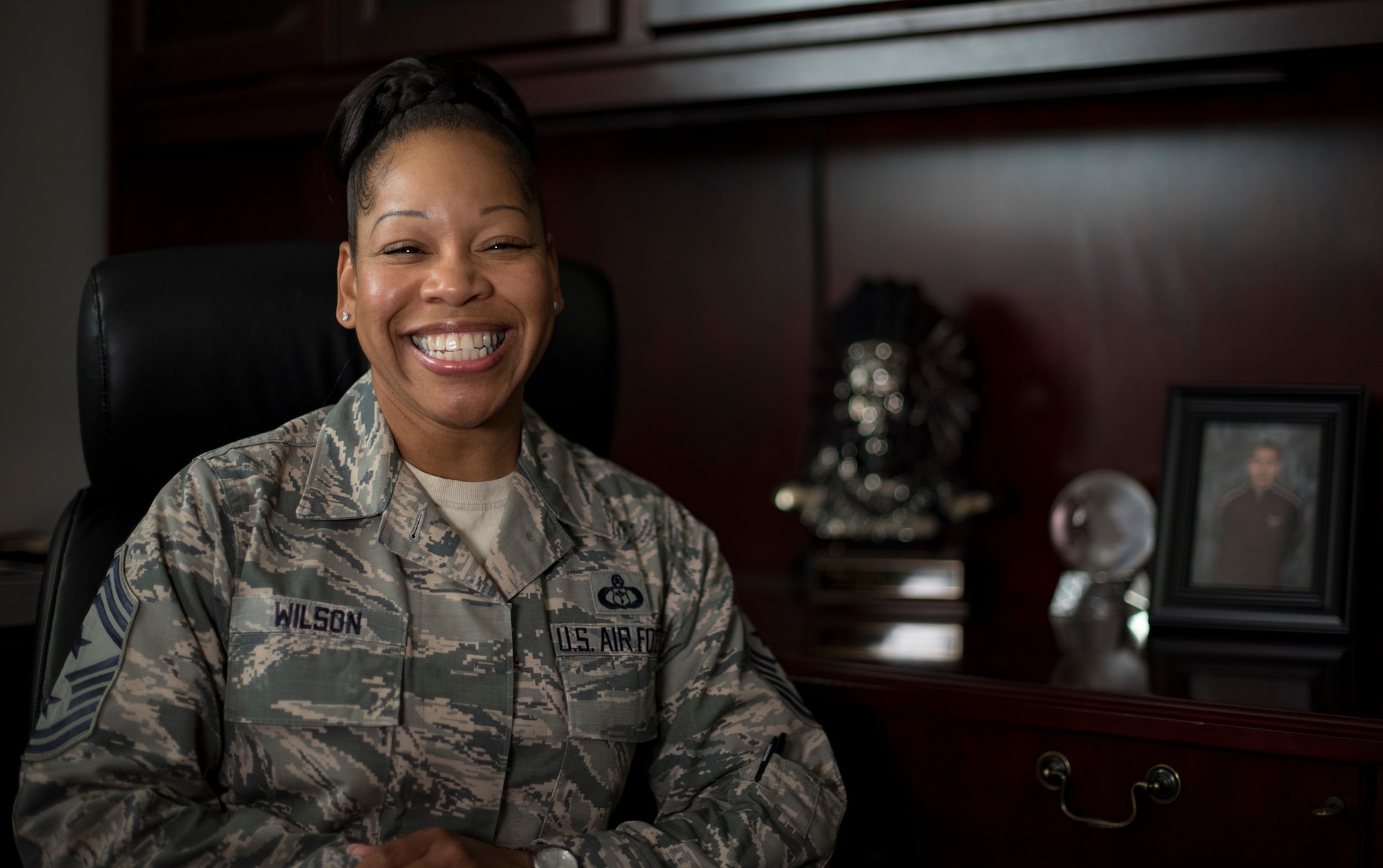 U.S. Air Force Chief Master Sgt. Yasmeen Wilson, 33rd Fighter Wing command chief, sits in her office May 9, 2018, at Eglin Air Force Base, Fla.  Wilson created a motivational group for women called W.I.N.G.S., "Women Inspiring the Next Generation's Successes," which focuses on personal and professional development, strengthens interpersonal communication skills, heightens self-awareness and encourages self-confidence. (U.S. Air Force photo by Airman 1st Class Daniella Peña-Pavao)