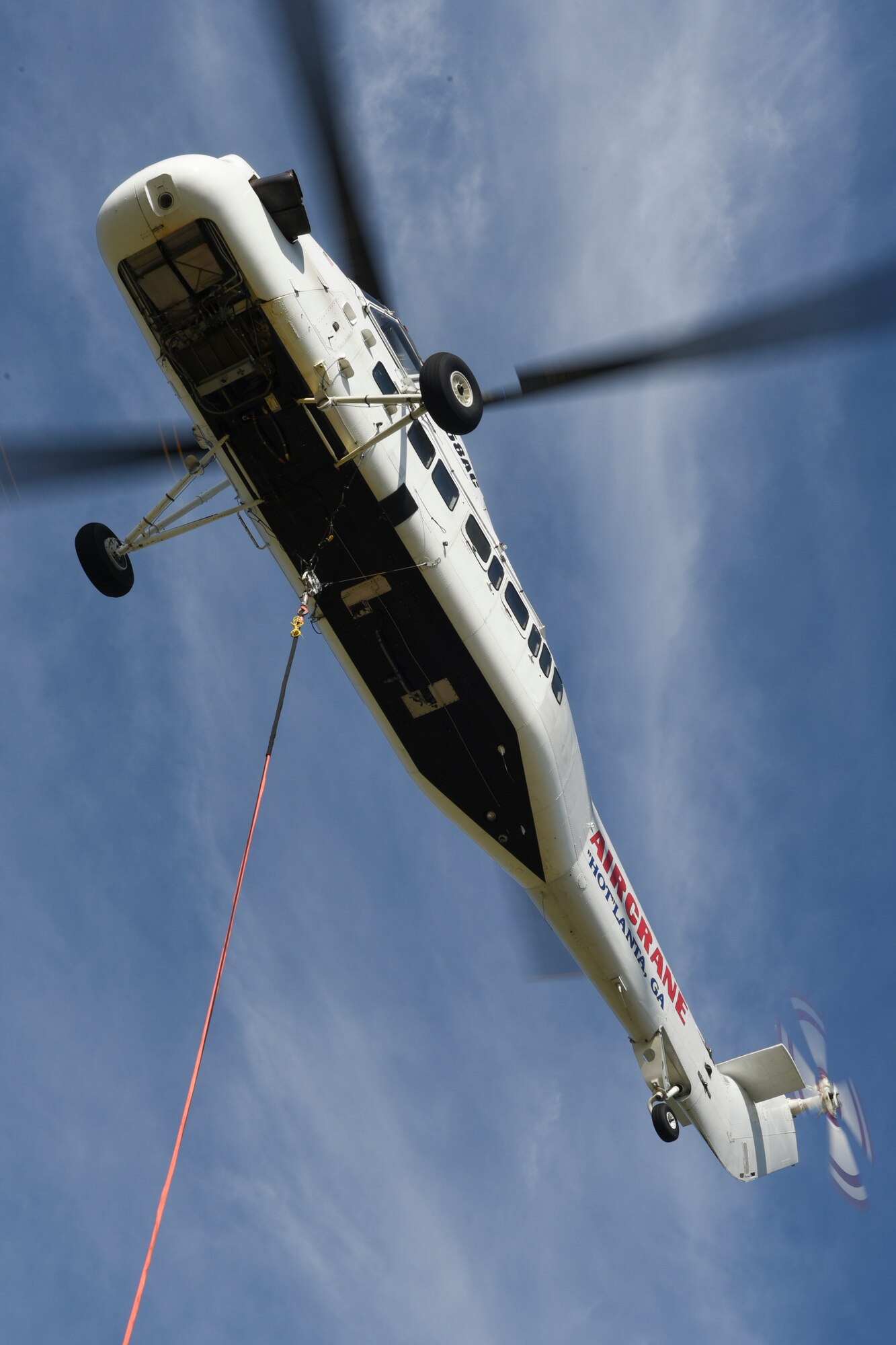 A Sikorsky S-58T heavy-lift helicopter from Aircrane Incorporated during lift operations May 27, 2018, Tinker Air Force Base, Oklahoma. The S-58T lifted 57 heating units to the roof of building 3001 as part of on-going energy efficiency improvements made across the base.