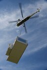 A Sikorsky S-58T heavy-lift helicopter from Aircrane Incorporated lifts a large heating unit May 27, 2018, Tinker Air Force Base, Oklahoma.