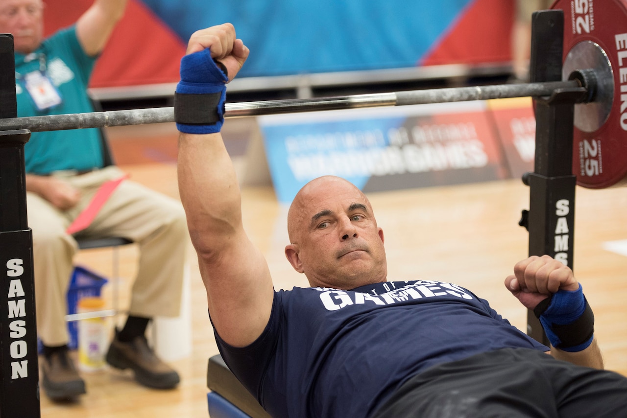 Navy Reserve Senior Chief Petty Officer Joe Paterniti cheers for Team Navy after competing in powerlifting during the 2018 Department of Defense Warrior Games at the U.S. Air Force Academy in Colorado Springs, Colo.